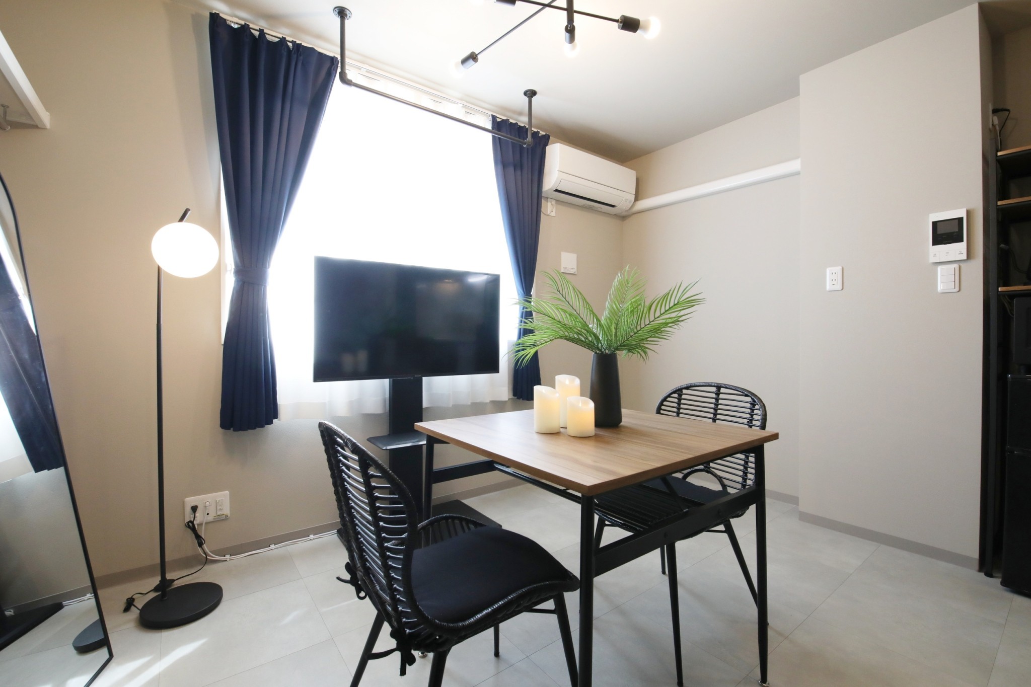 Room 101 dining area with Sharp TV and air conditioning