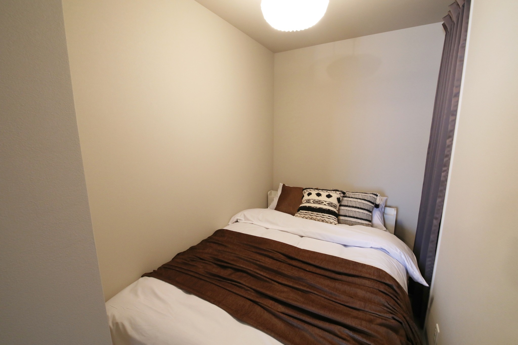 Room 103 private bedroom nook with curtain
